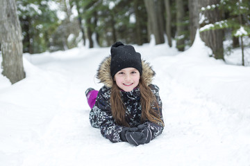 Fototapeta na wymiar Girl in winter clothes. Happy child outside photo