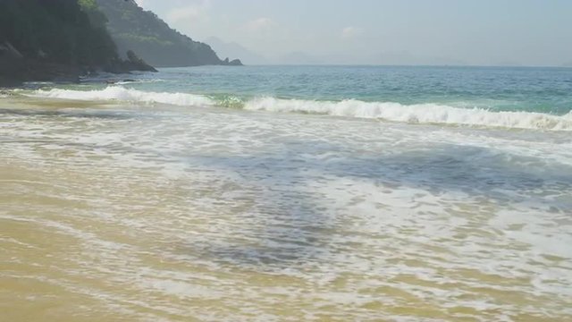 Slow motion of waves ebbing and flowing on the sand at Rio's Red Beach.