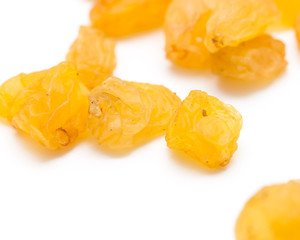 Golden raisins on a white background