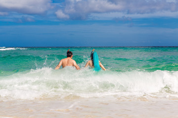 Happy couple having fun on the beach of a tropical island Summe