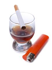 Whiskey cup and a cigarettes on white