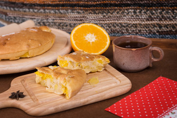 Pieces of orange-apple pie on the wooden board