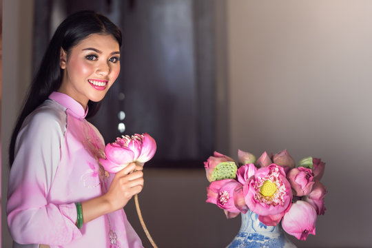 Portrait of Vietnamese girl traditional dress with lotus