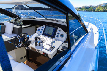 Steering boat of luxury motoryacht at sunset