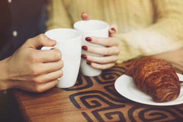 Couple in love drinking coffee. Hands close up