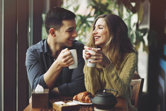 Couple in love drinking coffee in coffee shop