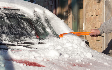 scraping snow from car winter