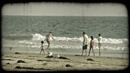 People play on beach. Vintage stylized video clip.