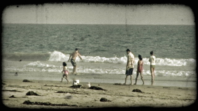 People play on beach. Vintage stylized video clip.