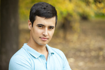 Portrait of Arabic nice man on the background of autumn park