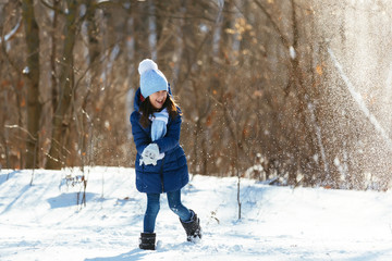 Fototapeta na wymiar Little girl outdoors on beautiful winter snow day