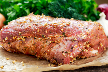 Fresh pork carbonade, meat marinated and prepared for roast with garlic, herbs