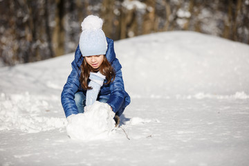 Fototapeta na wymiar Little girl outdoors on beautiful winter snow day