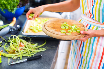 Young woman cooking in her modern kitchen 