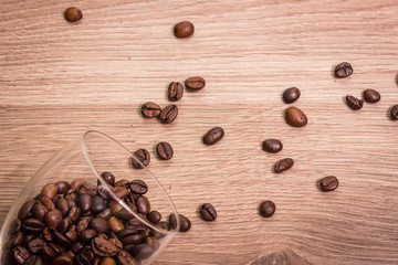 coffee beans in a glass and on a wooden table