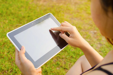 Woman using digital tablet outdoors