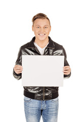 Fototapeta premium young man holding a blank panel against a white background