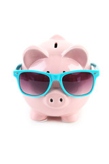 Pink piggy bank with dollars on white wooden background