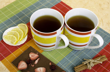Two cups tea, chocolate, lemon and cinnamon.