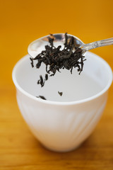 fall dried black tea into cup