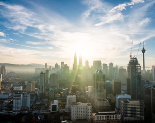 View of the amazing Kuala Lumpur skyline with the Petronas Towers in Malaysia at sunrise / dawn.
