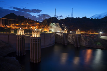 Hoover Dam, once known as Boulder Dam, is a concrete arch-gravity dam in the Black Canyon of the Colorado River, on the border between the U.S. states of Nevada and Arizona.  At twilight blue hour.