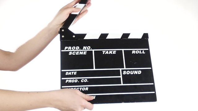 Person uses movie production clapper board, on white, slow motion