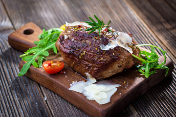 Beef steak on a wooden table.
