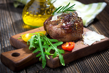 Beef steak on a wooden table.
