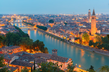 Verona skyline with river Adige, bridges, Santa Anastasia Church and Torre dei Lamberti or Lamberti Tower at evening, view from Piazzale Castel San Pietro, Italy