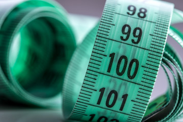 Curved measuring tape. Measuring tape of the tailor. Closeup view of Green measuring tape.