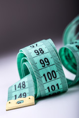 Curved measuring tape. Measuring tape of the tailor. Closeup view of Green measuring tape.