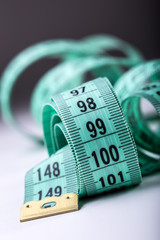 Curved measuring tape. Measuring tape of the tailor. Closeup view of Green measuring tape.