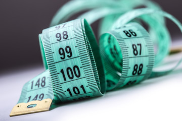 Curved measuring tape. Measuring tape of the tailor. Closeup view of Green measuring tape.