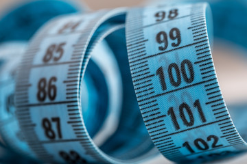 Curved measuring tape. Measuring tape of the tailor. Closeup view of blue measuring tape.