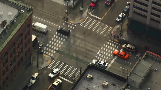 4 way stop intersection, light traffic and pedestrians walking the streets of a generic city, Seattle.