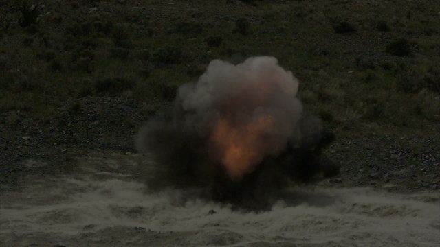 Fiery explosion in slow motion, shock wave visible.