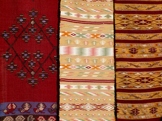 Close up of three hanged colourful handmade traditional wool rug