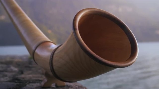 Racking-focus close-up of alphorn mouth