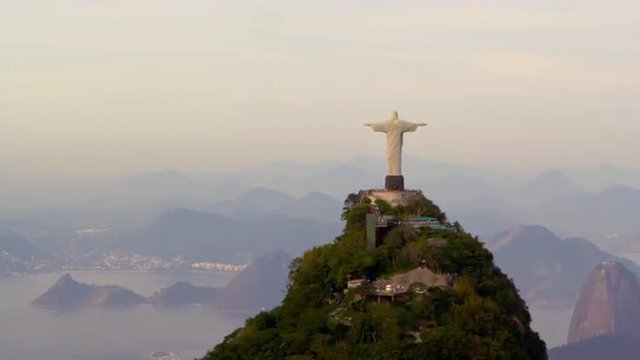 Aerial tracking footage of Christ Redentor overlooking bay