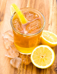 Summer drink with lemon on wooden base