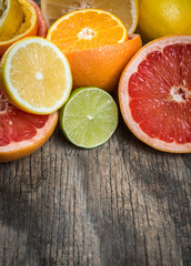Fototapeta na wymiar Fresh citrus fruits on rustic wooden background, closeup