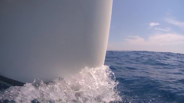 Burun water on the bow of the floating yacht. Side view, close-up.
