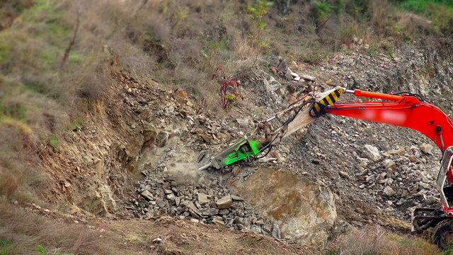 Large jackhammer construction machinery smashing rocks. 