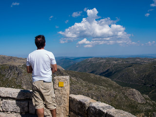 Back view of a man looking to the mountain