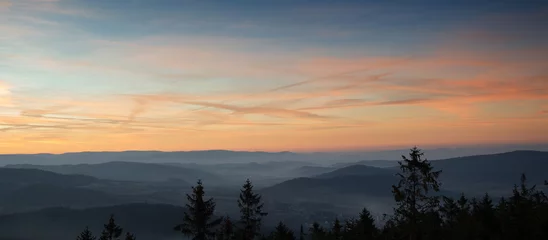 Abwaschbare Fototapete Sunset over the hills in the fog. © Castigatio