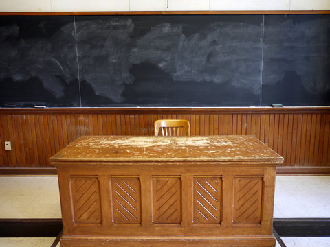 Old Fashioned Wooden Teacher's Desk In Classroom