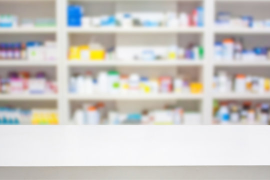 Pharmacy Counter With Blur Shelves Of Drug In The Pharmacy Drugs