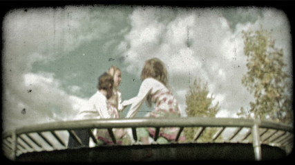 Children play on trampoline 2. Vintage stylized video clip.