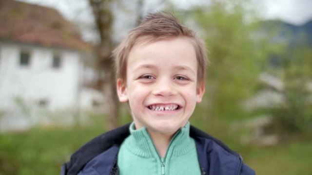 Slow motion of kid smiling in camera